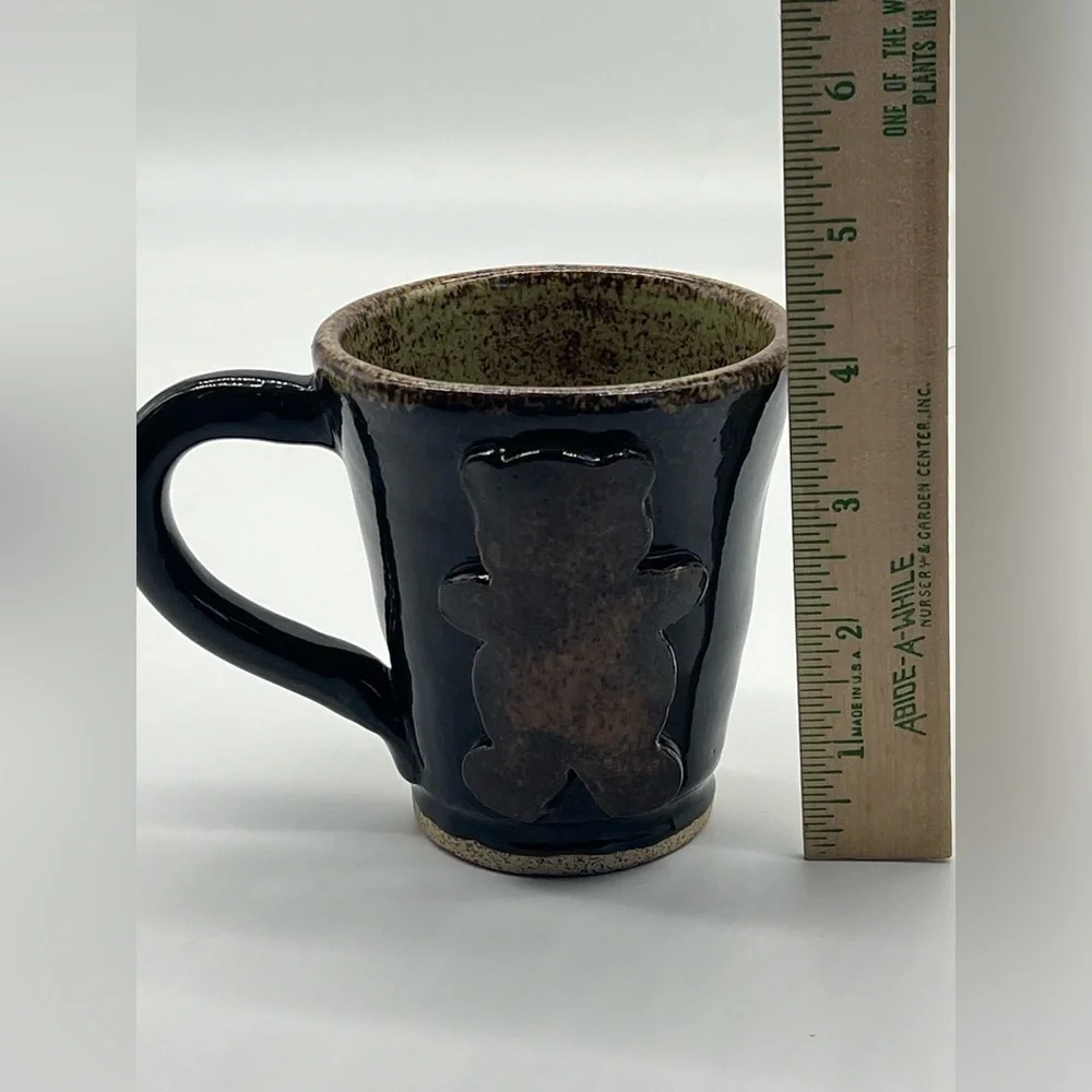 Handmade studio pottery mug with rustic bear design
